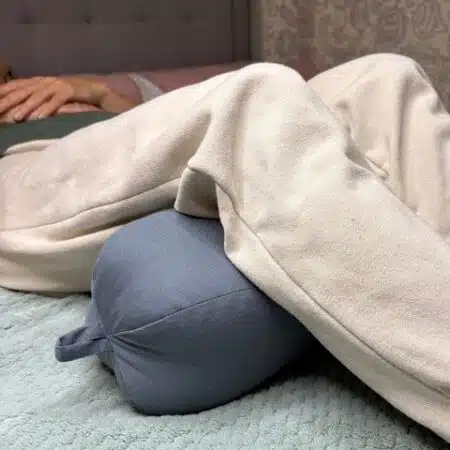 big peanut pillow under legs